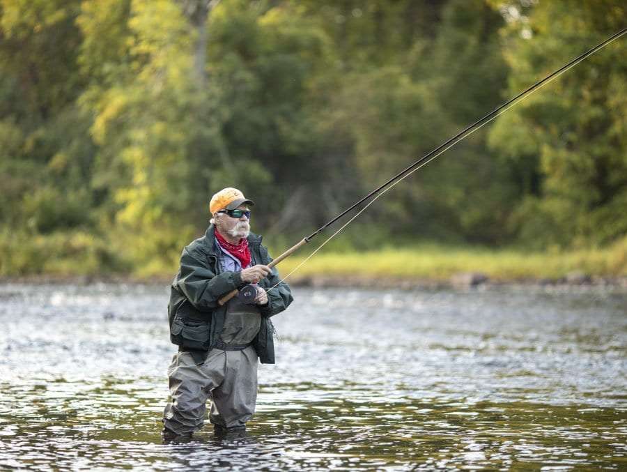Anglers fish for salmon in the Saranac in an unlikely spot