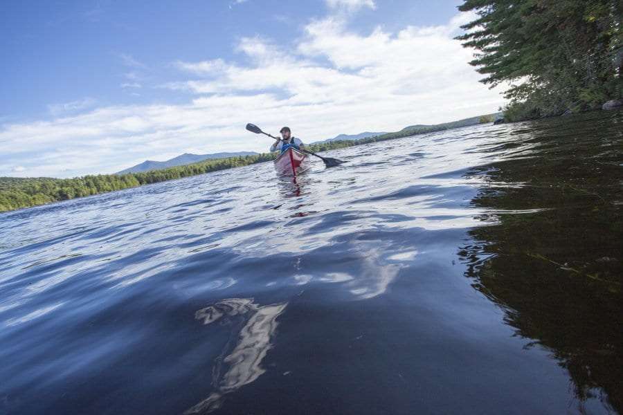 Chris Morris paddles Union Falls Pond on the Saranac River. Photo by Mike Lynch