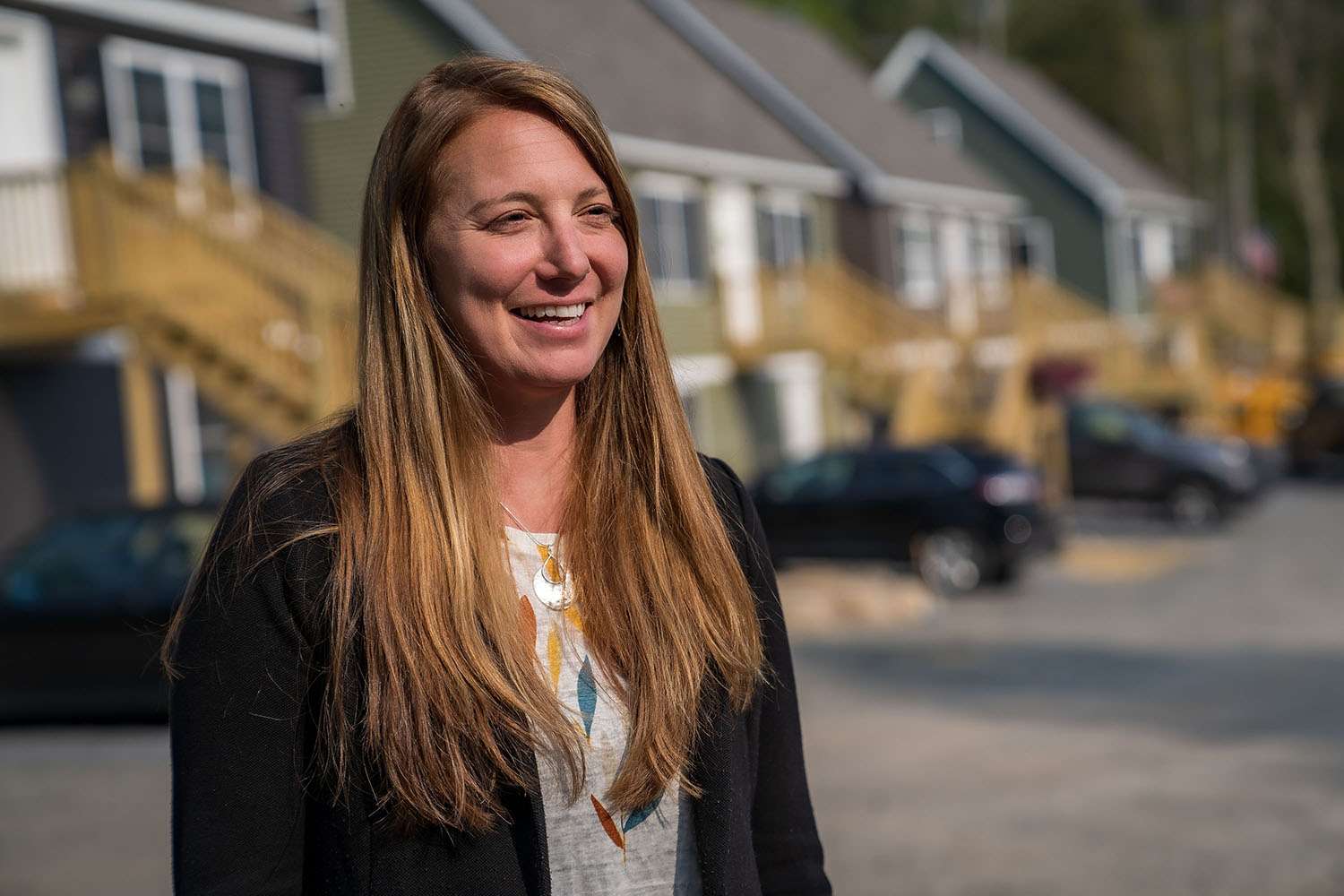 woman in front of housing development