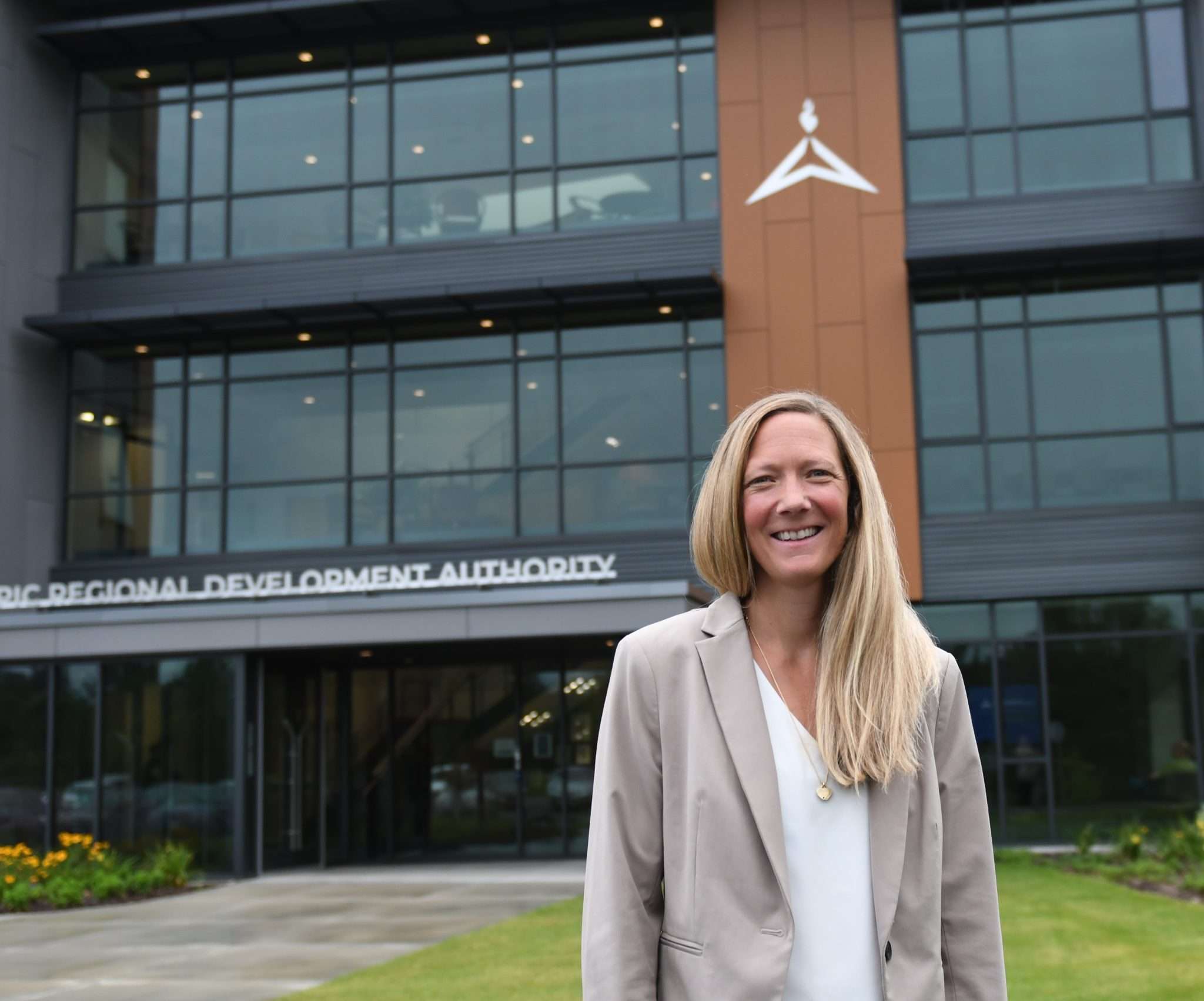 blond woman, Ashley Walden, the new ORDA CEO in front of Olympic facility building