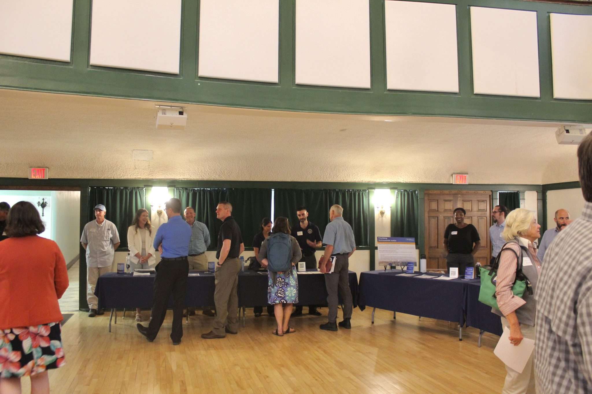 Participants speak with experts in an auditorium