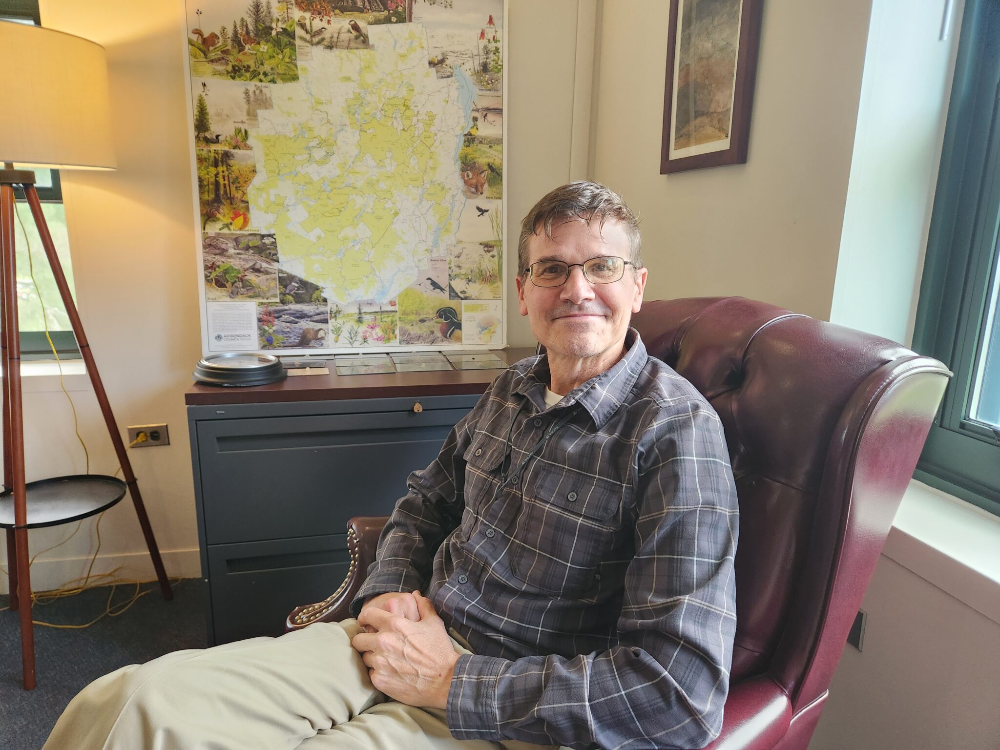 dan kelting sitting in a chair in his paul smith's college office