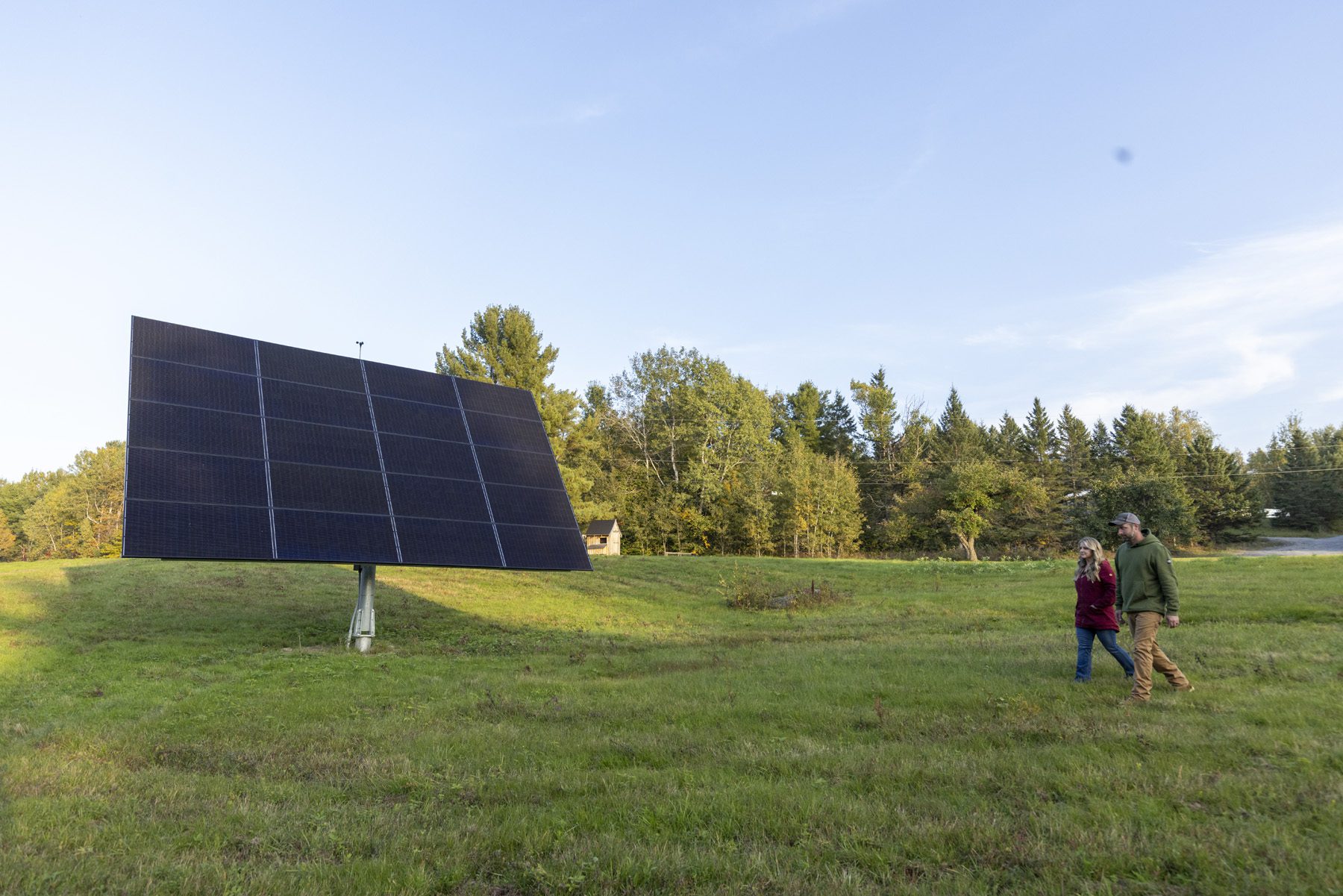 Broc and Jennifer Jennings, of ADK Solar, walking on their property in Saranac