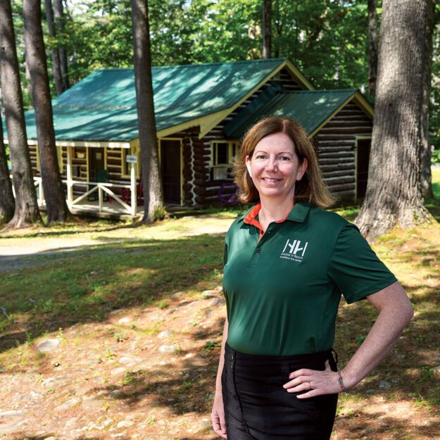 woman in green in woods