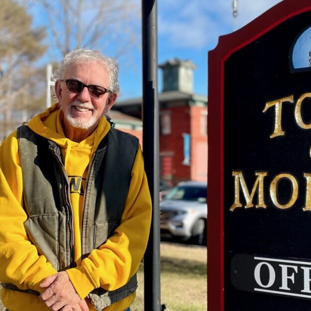 Tom Scozzafava standing next to Town of Moriah sign