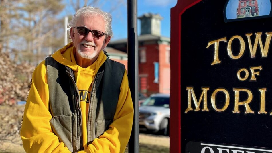 Tom Scozzafava standing next to Town of Moriah sign