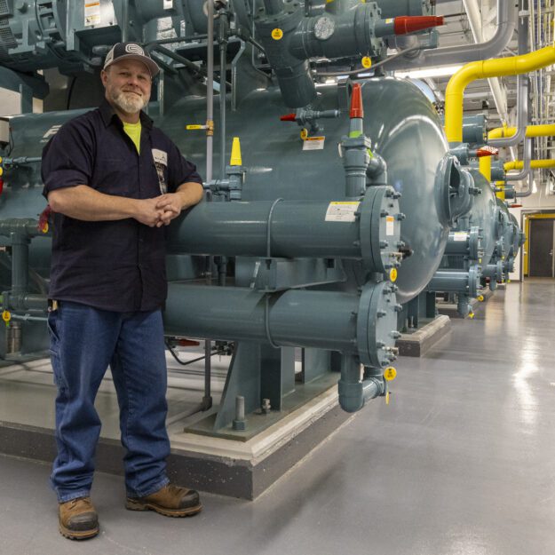 man in front of green machine