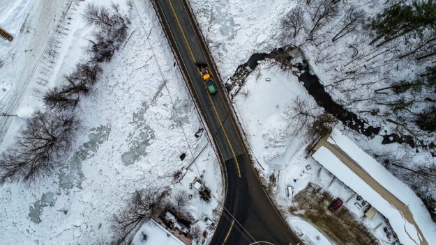 aerial shot of a road salt truck on a highway