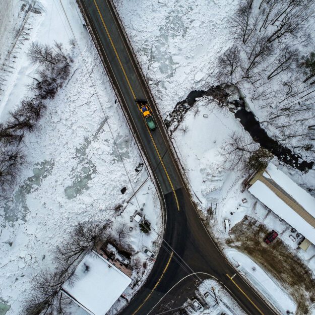 aerial shot of a road salt truck on a highway