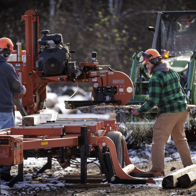 Participants of Paul Smith's College forestry program mill wood. Photo provided by Paul Smith's College