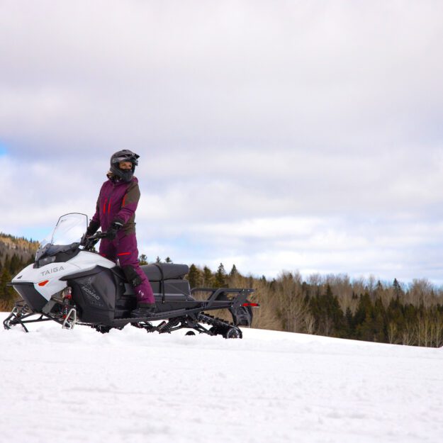 A snowmobile rider on an electric snowmobile.