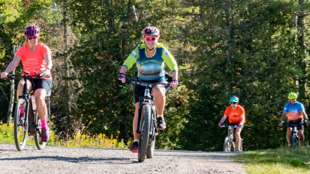 people riding e-bikes