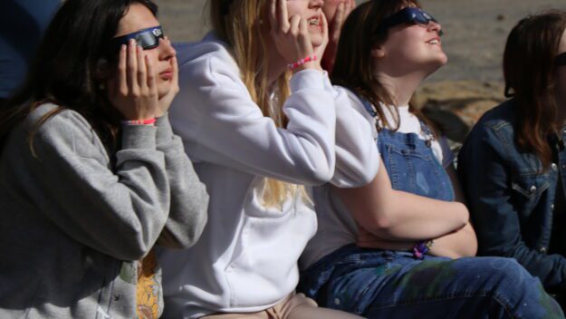 The Girl Scouts of Northeastern New York and their families watch the solar eclipse at Hidden Lake Camp in Lake Luzerne. Photo by Gwendolyn Craig