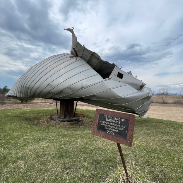 Ted Cornell’s Phoenix of Wadhams, a metal sculpture outside in a field