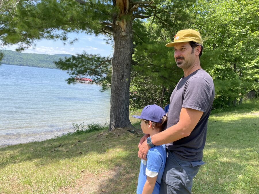 man and boy at water's edge in Lake George