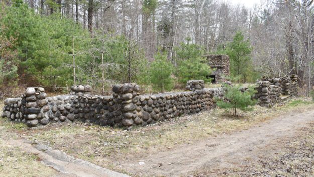 An old stone foundation in the woods.