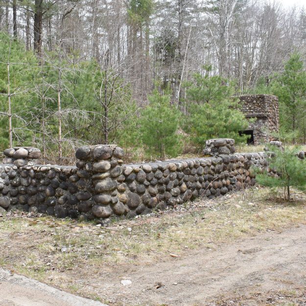 An old stone foundation in the woods.