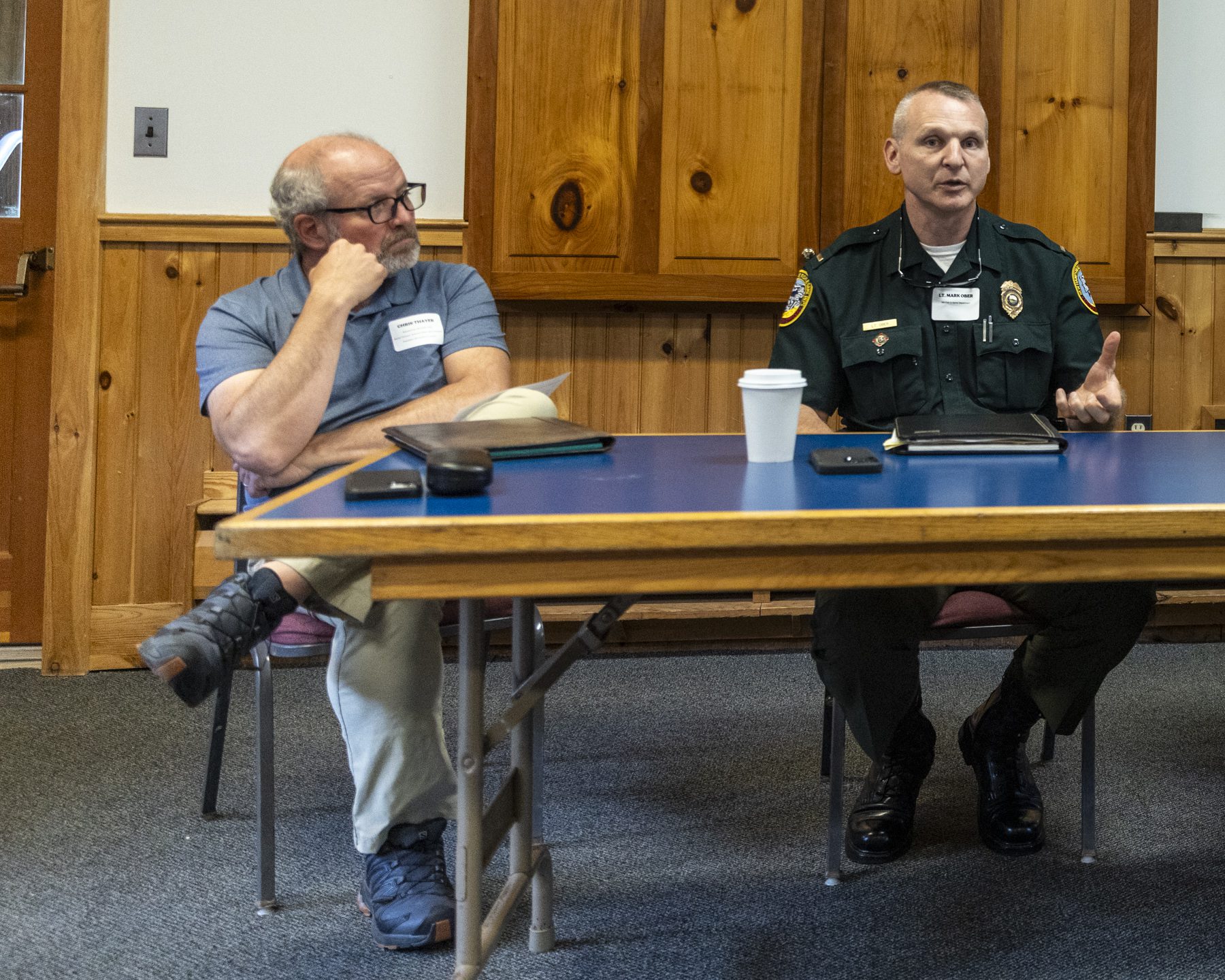 Lt. Mark W. Ober, New Hampshire Fish and Game Department, right, talks about search-and-rescue missions as Chris Thayer, board of directors for New Hampshire Outdoor Council and AMC’s director of external affairs and contracts, listens. Photo by Mike Lynch