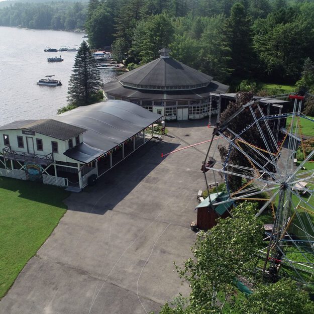 An overhead shot of an old amusement park with a ferris wheel and merry-go-round.