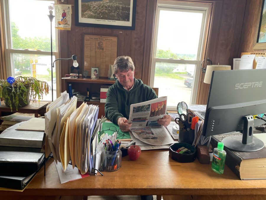 dan mcclelland at his desk at the Tupper Lake Free Press