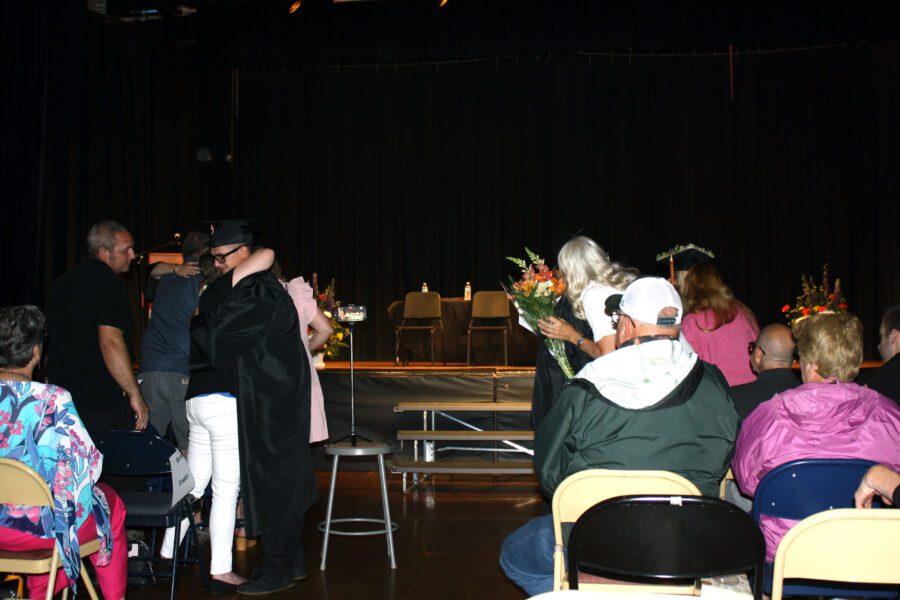 Joseph Brouthers hugs his mother at the end of graduation.