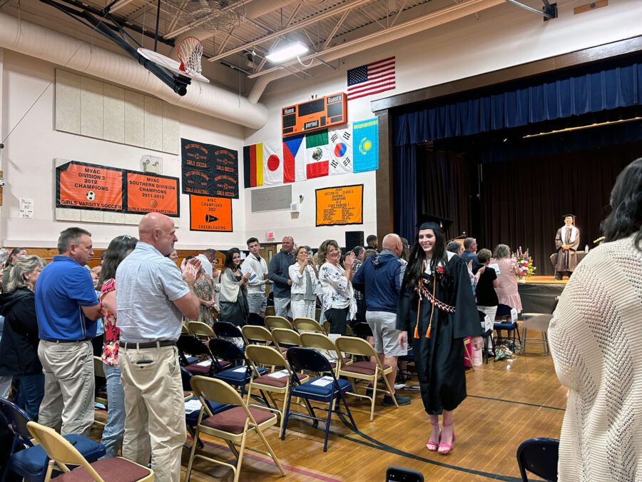 indian lake graduate walks through the crowd