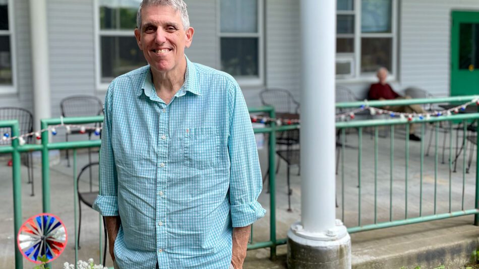 man standing in front of assisted living facility in Keene Valley