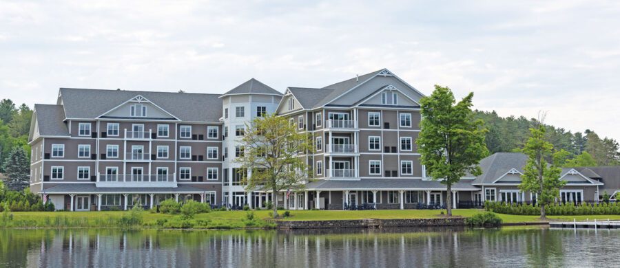 Large grey waterfront hotel.