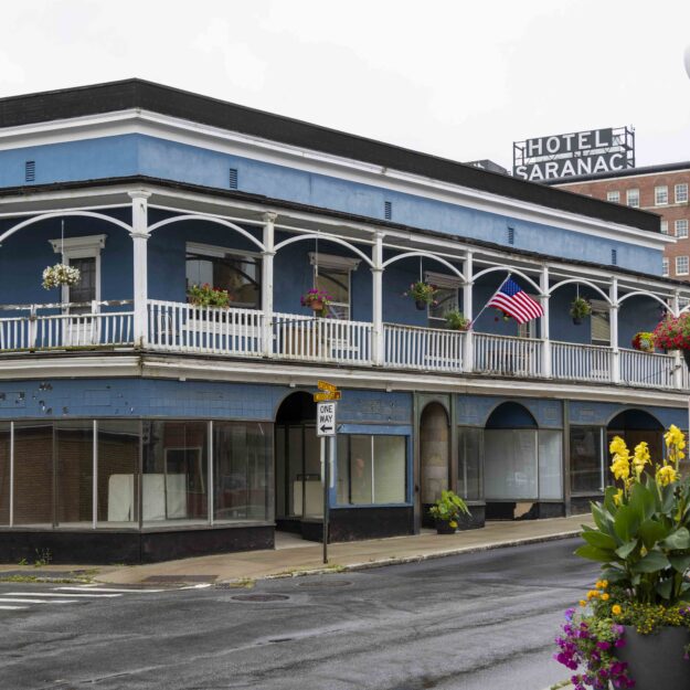 blue colored historic Loomis building in Saranac Lake