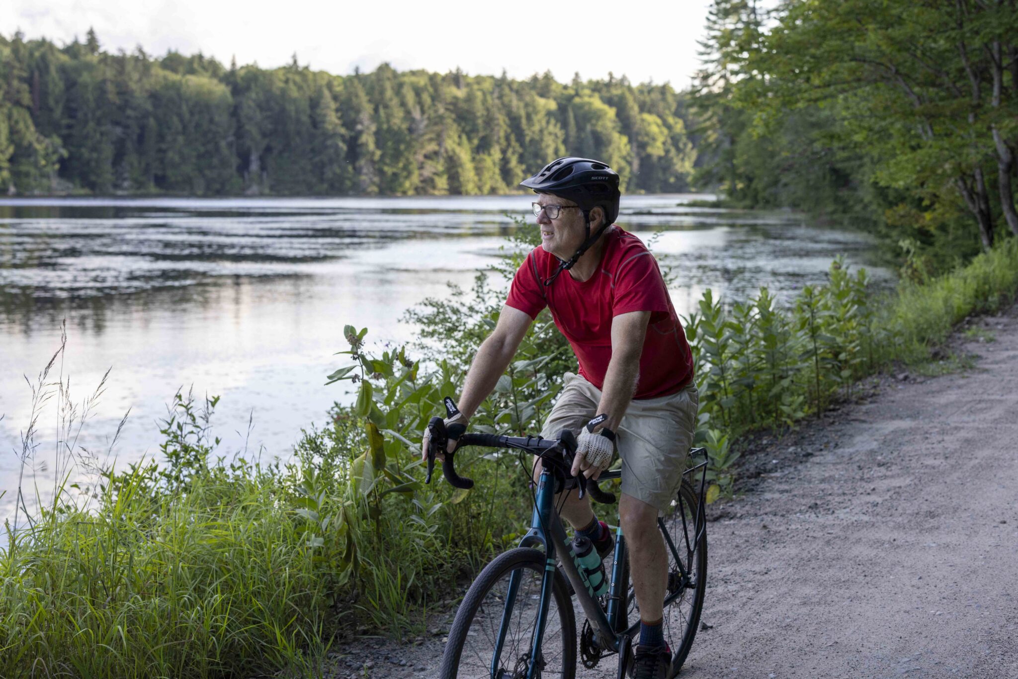 Phil Brown bikes down Floodwood Road alongside Middle Pond. Photo by Mike Lynch