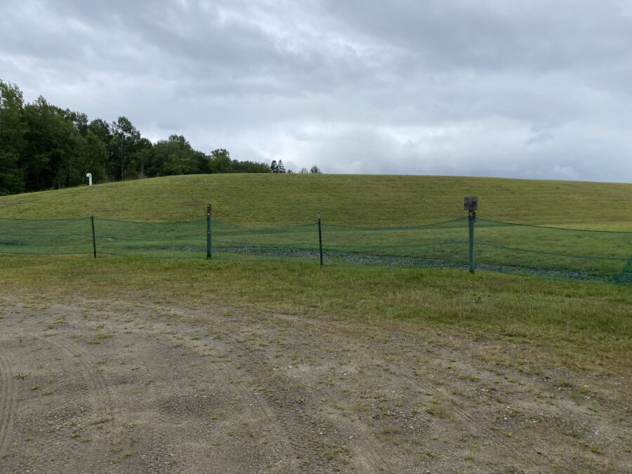 A capped landfill with grass