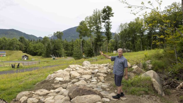 Kris Cheney-Seymour, program manager at Mount Van Hoevenberg, describes how mountain bikers will go through this rock garden. Photo by Mike Lynch