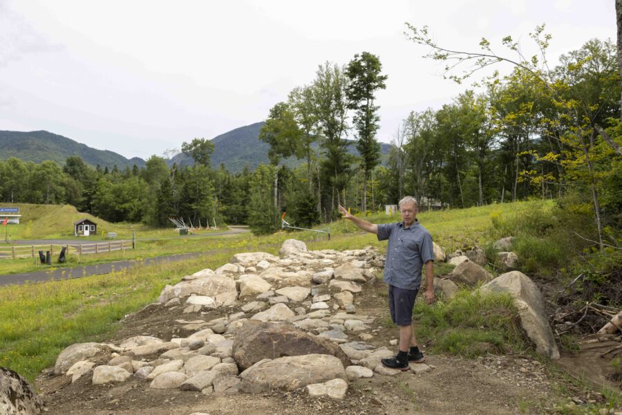 Kris Cheney-Seymour, program manager at Mount Van Hoevenberg, describes how mountain bikers will go through this rock garden. Photo by Mike Lynch