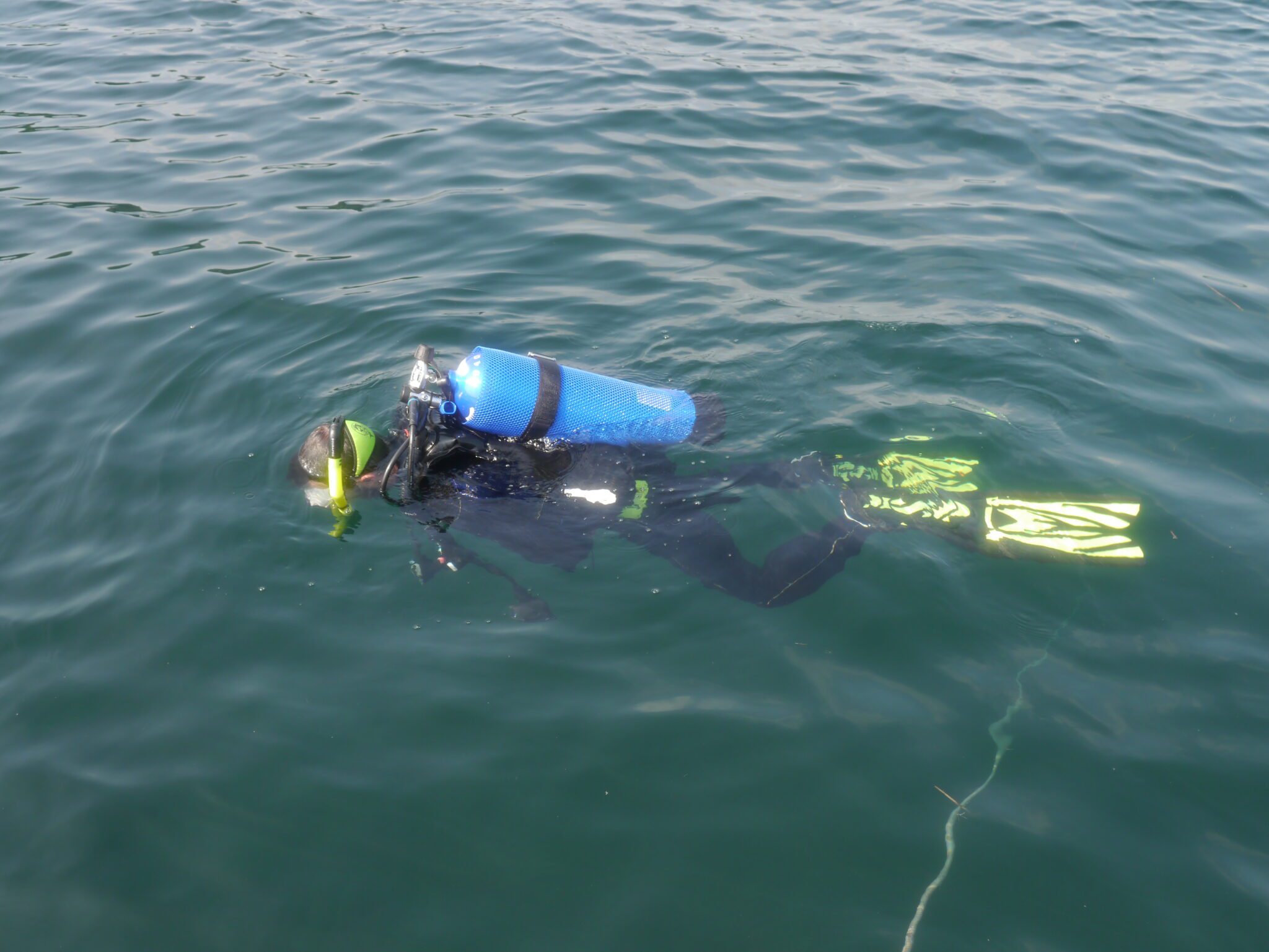 a man in a scuba suit on the surface of the water in lake george