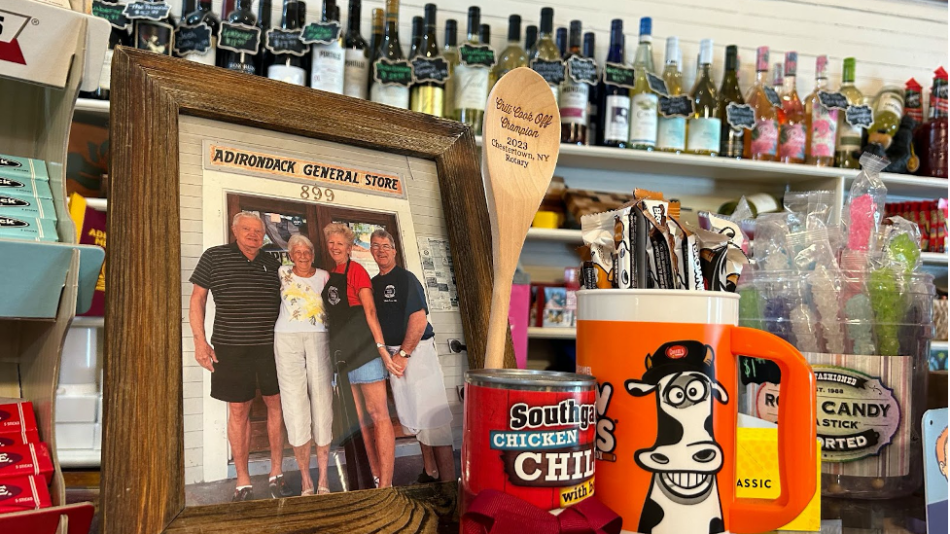 A family photo of Diane Cain sits atop her vintage candy display, beside an award for winning the local chili cookoff.