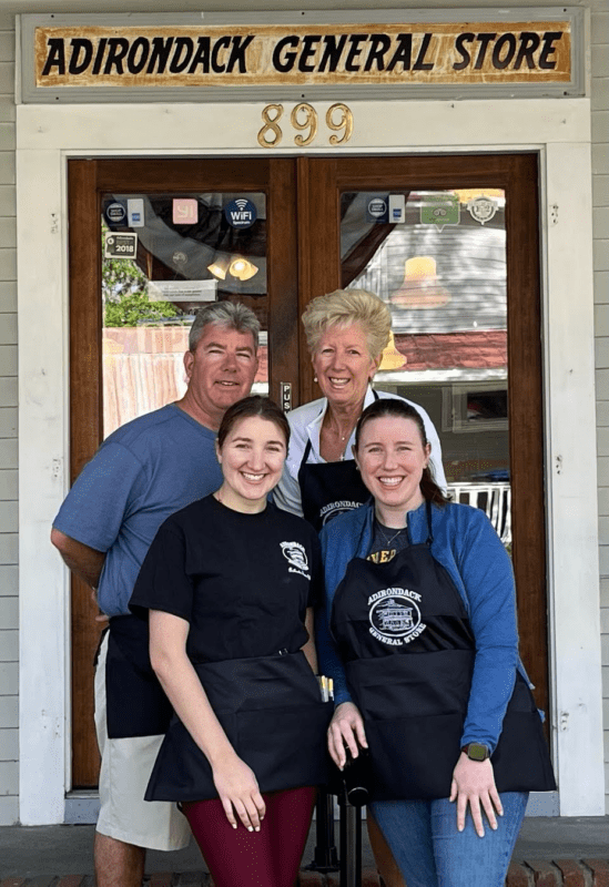 a family poses in front of Adirondack General Store