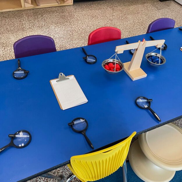 blue kids table with magnifying glasses at each seat