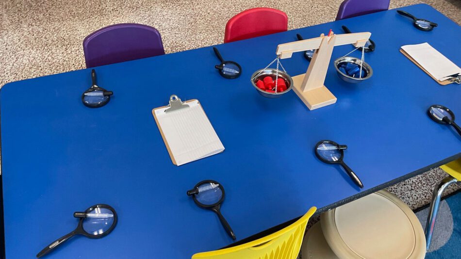 blue kids table with magnifying glasses at each seat