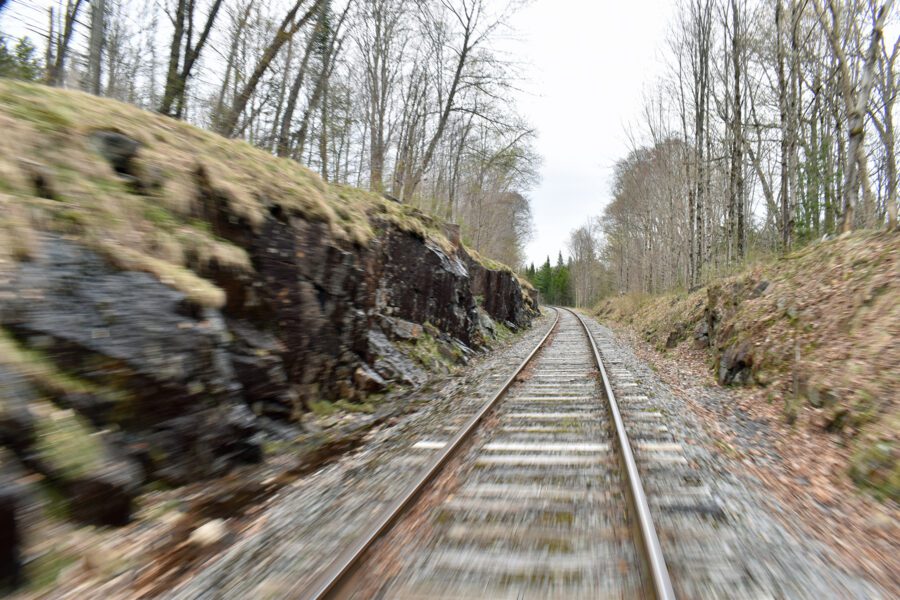 View of the rail tracks ahead from a moving rail car.