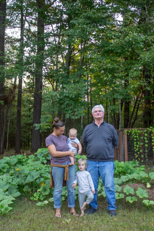 A family stands in front of a garden in Jay, New York