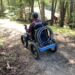 DEC/APA Accessibility Advisory Committee member Scott Remington rides quadracycle at Great Camp Santanoni.