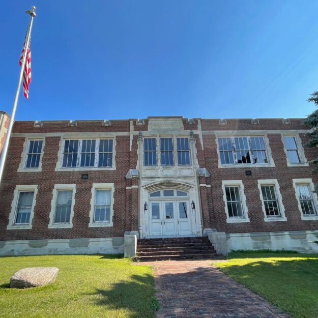 The exterior of a red brick school building