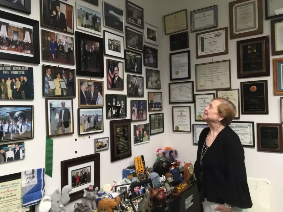 Edinburg Supervisor Jean Raymond looks at the collection of framed photos in her office at Town Hall on Aug. 21, 2019. The photographs span her years in office. 