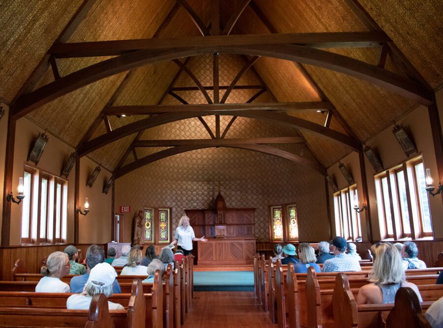 Interior of church with people sitting at the pews