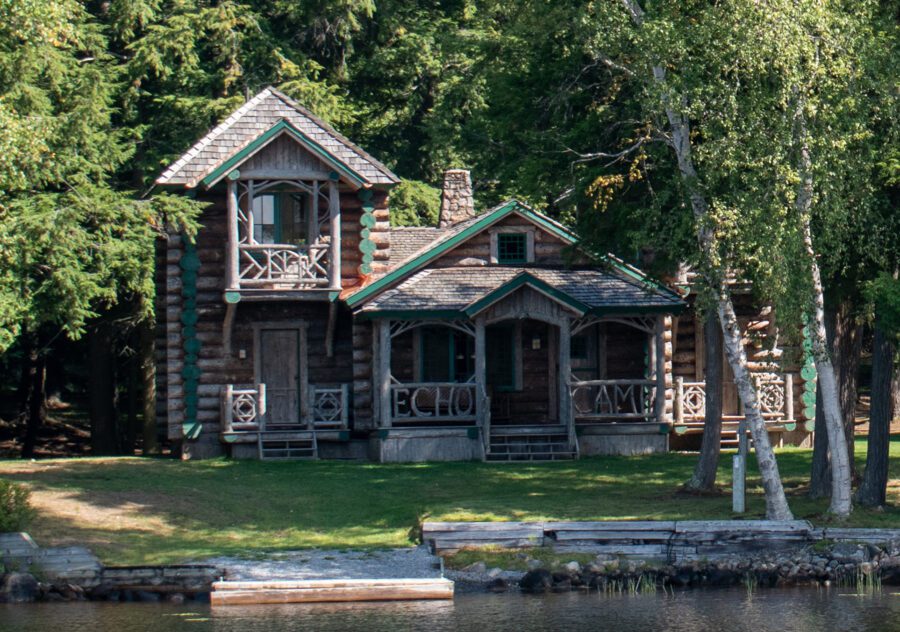 Wooden log-cabin style camp facing a lake