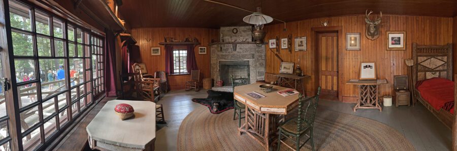 Panoramic photo of a great room in an Adirondack camp