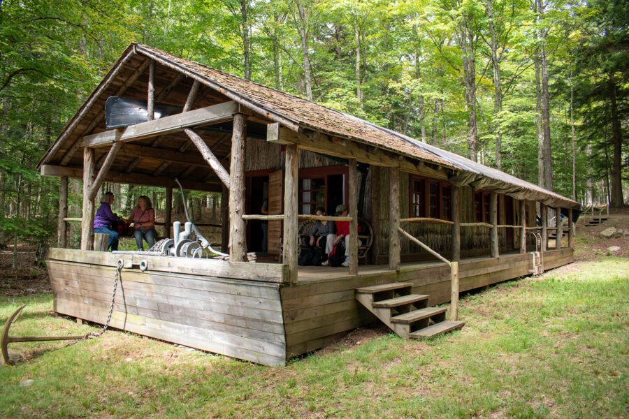 Wooden houseboat converted into a cabin in the woods