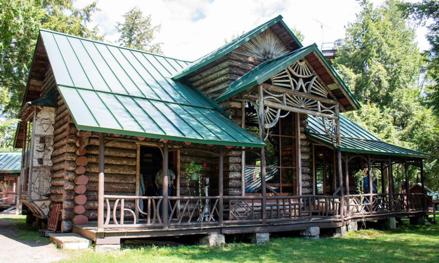 Log cabin camp with woodworking detail and a large porch